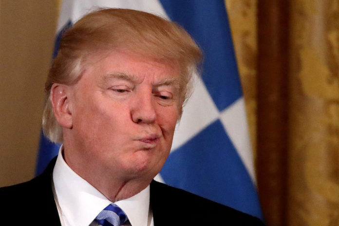 President Donald Trump reacts as he hosts a Greek Independence Day celebration at the East room of the White House in Washington